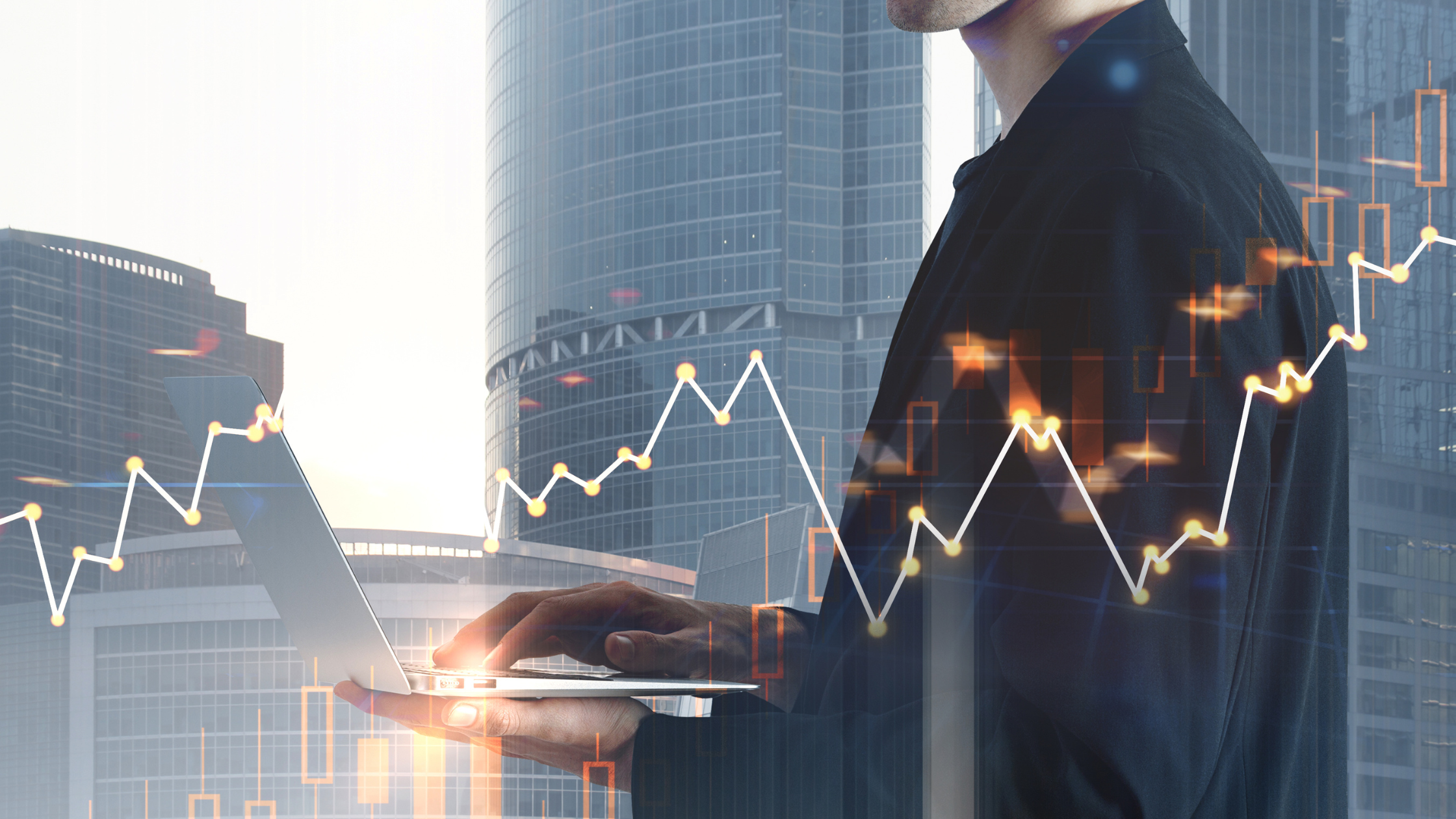 Professional standing in front of skyscrapers holding a laptop and analyzing market performance.