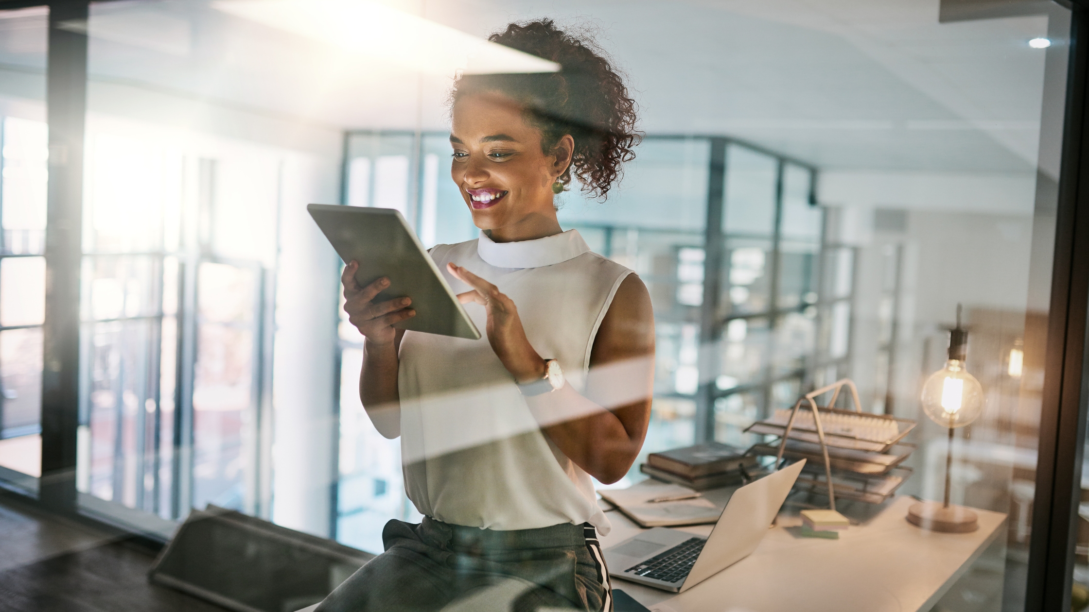 Happy employee reviewing their financial plan on a tablet.