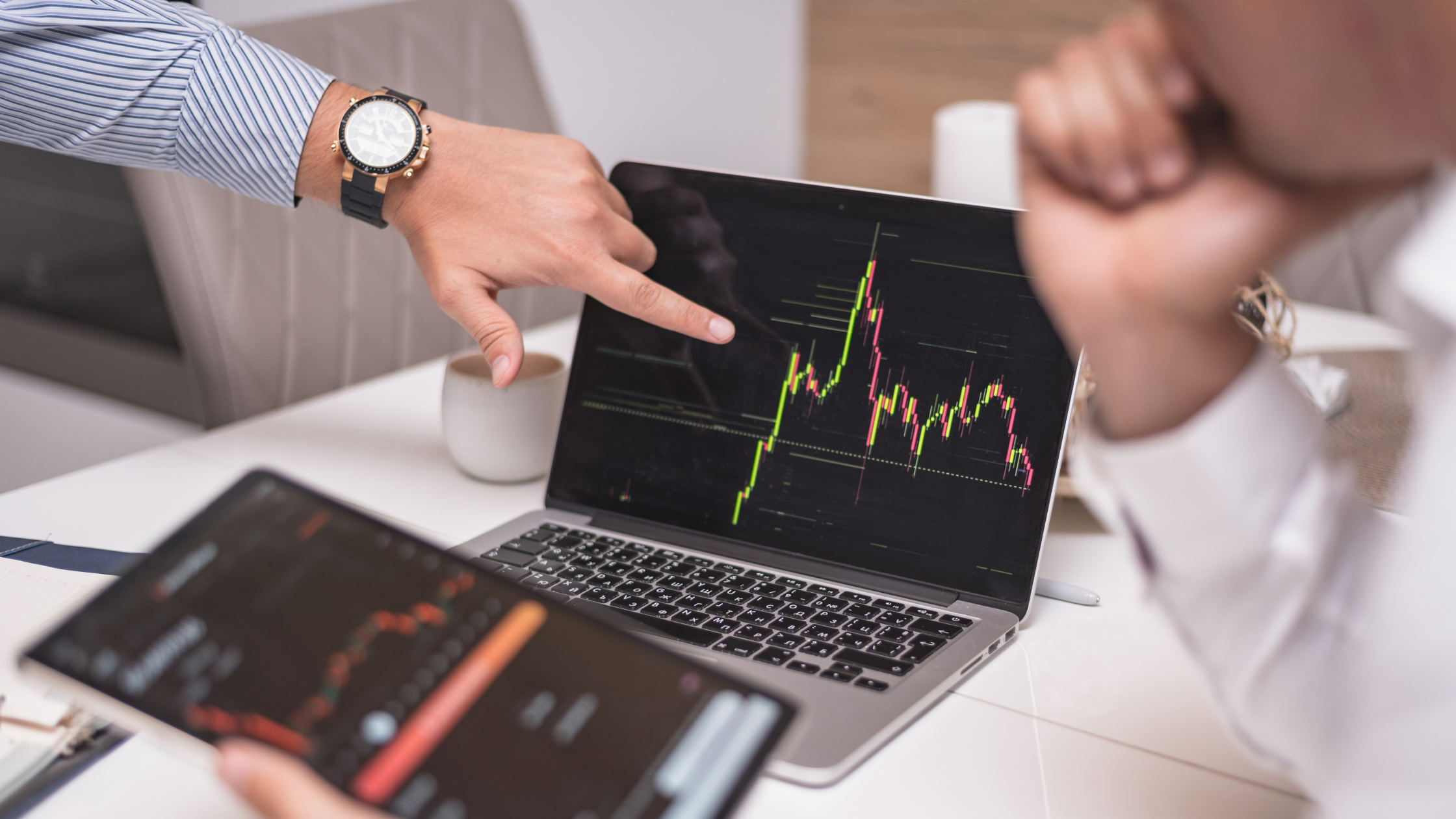 Two people reviewing stock options.
