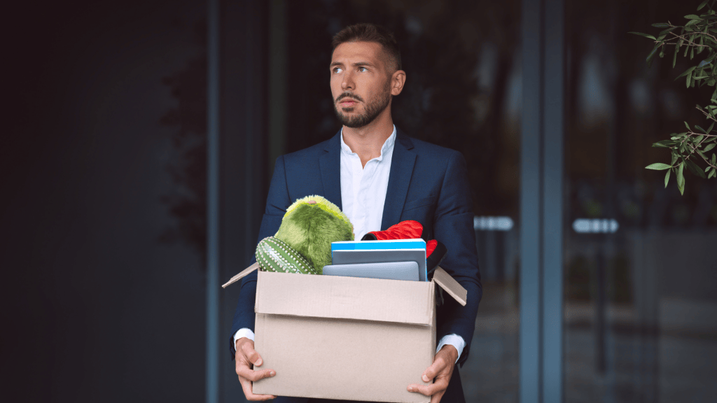 Man carrying box of things out of office