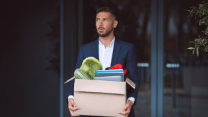 Man carrying box of things out of office